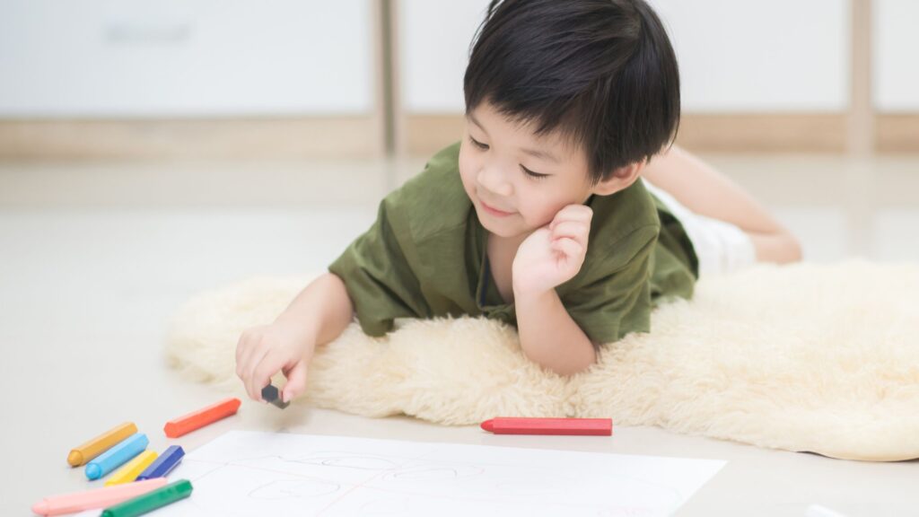 a young boy drawing a picture
