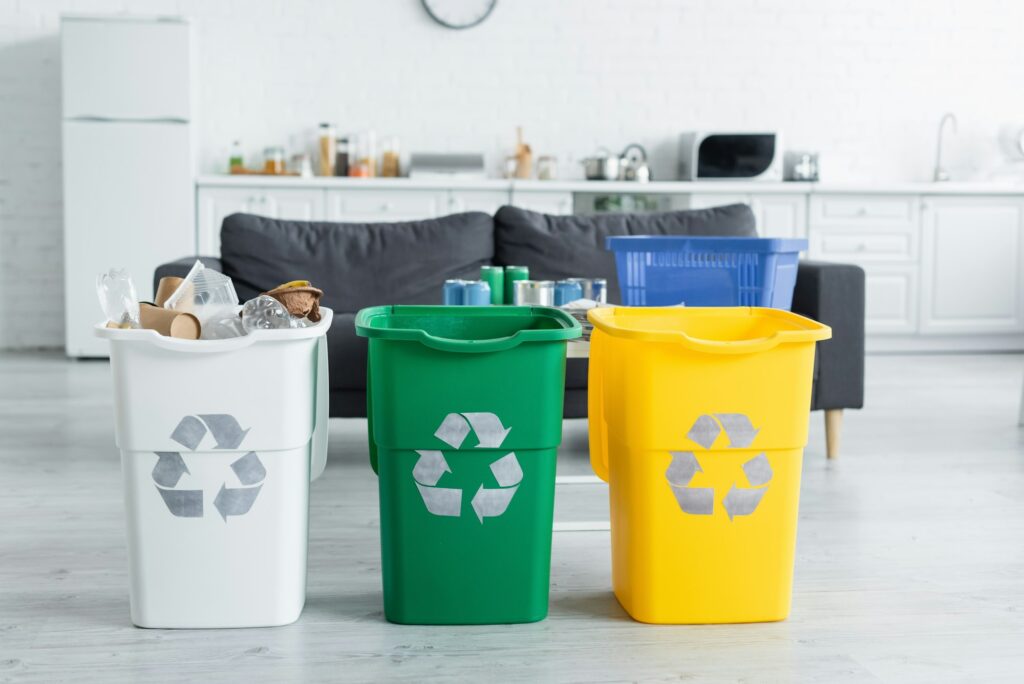 Trash cans with recycle sign in kitchen - An Expat Mum’s Guide to Living an Eco-Friendly Lifestyle